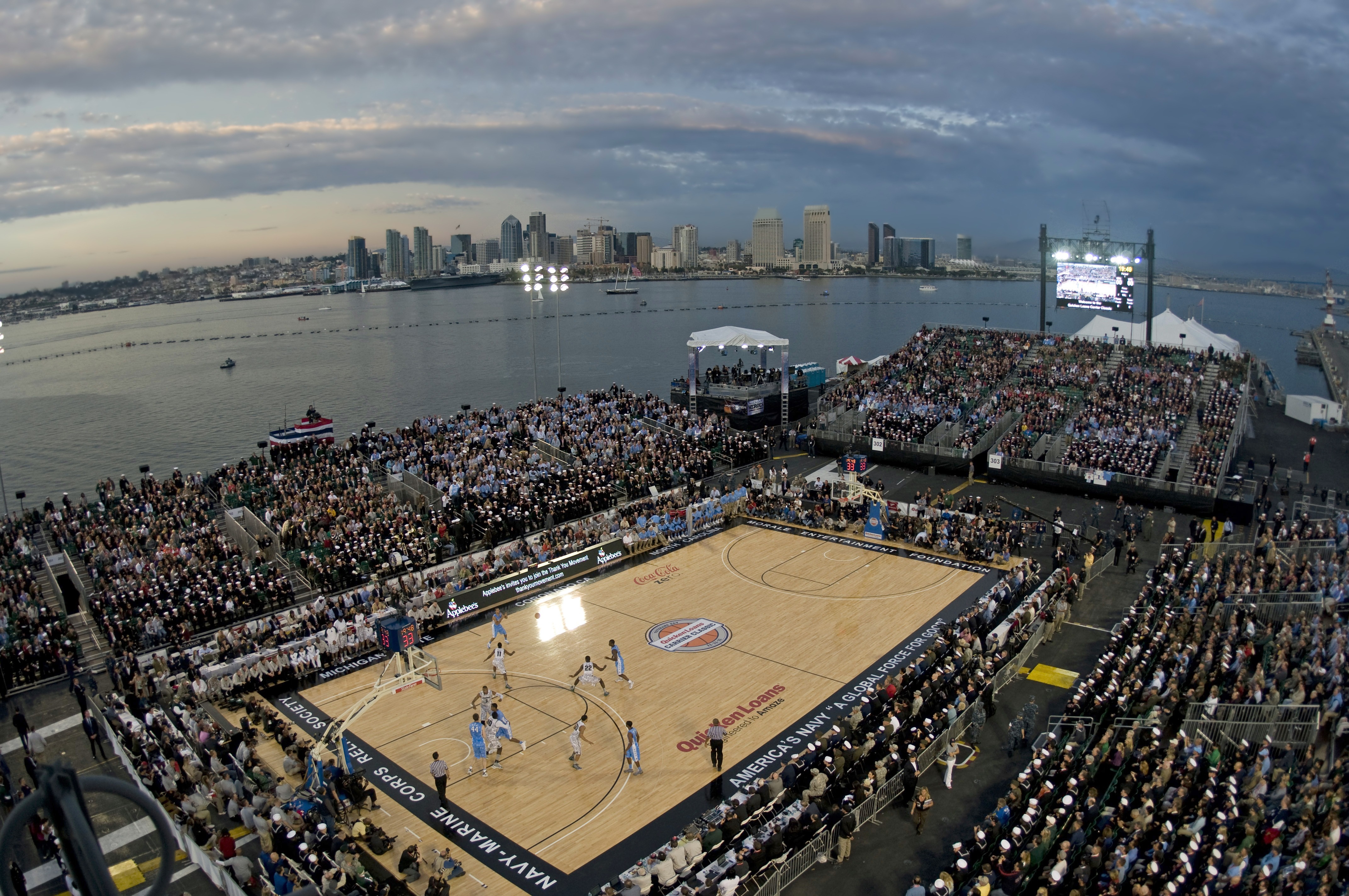 Wide-angle pregame shot of a packed high school basketball gym