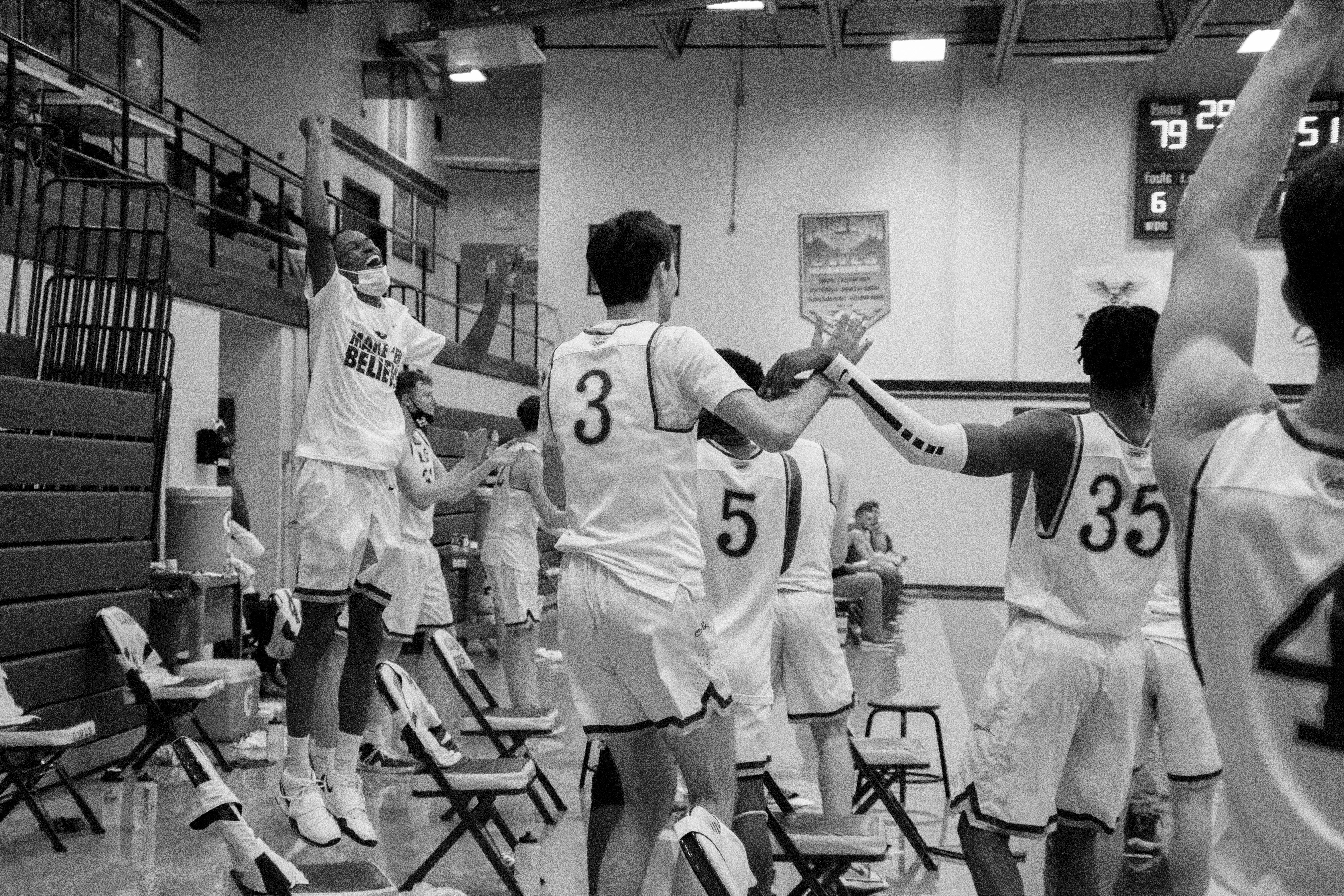 High school team celebrating on the sideline during a streamed game